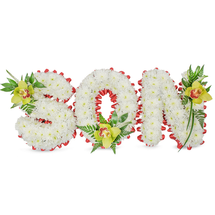 This meticulously arranged memorial piece reads plainly and powerfully: SON, formed as three-dimensional block letters built from countless small, immaculate white chrysanthemums that create a sculpted, cloud-like surface. The composition rests against a simple white field, allowing the textures, shadows, and the careful silhouette of each letter to register without distraction. A continuous band of red ribbon is artfully looped around the perimeter of each letter, producing a scalloped, decorative edge that punctuates the whiteness with a luminous, almost heartbeat-like red. Anchoring the design and adding a gentle burst of colour are three lime-green Cymbidium orchids - one tucked into the S's upper curve, one cradled within the O's hollow, and one placed on the N's upper stroke - each showing subtle pale orange to reddish-brown markings at its throat and a satiny, waxy sheen. Sprays of delicate fern fronds and longer glossy leaves accompany each orchid, introducing verdant texture and a sense of uplift. The overall mood is solemn yet tender: the white chrysanthemums convey purity and remembrance, while the red ribbon and orchids suggest love, courage, and personal tribute. This piece is clearly intended as a funeral or graveside floral tribute for a son, crafted with attentive florist workmanship that families in Harlesden and nearby Willesden Junction or Kensal Green often request when they want a personalised, meaningful display to honour a life.