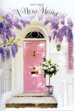 Captured in gentle afternoon light, this Harlesden doorway arrangement speaks softly of new beginnings and warm welcomes. A pastel pink front door, its surface smooth yet subtly brushed, glows against whitewashed walls that reflect the brightness of the day, evoking the cheerful spirit of nearby local streets and terraces. Overhead, wisteria drapes in abundant lavender cascades, the flower clusters hanging like fragrant tassels that sway ever so slightly, creating a dreamy canopy above the entrance. The wisteria's twisting stems and delicate leaves frame the door and pale shutter, softening every line and filling the space with a sense of romance and calm. Resting right on the doorstep is a generous floral display in a simple grey tin-style bucket, carefully placed as though just delivered to congratulate the new occupants. Inside, plump white and cream roses bloom in full, rounded shapes, their velvety petals layered closely together as if cradling secret wishes. Wisps of soft green foliage weave between the roses, adding freshness and depth, like the greenery you catch glimpses of in Harlesden's quieter gardens. A soft pink ribbon is tied around the base of the bucket, its satin bow mirroring the door's blush tone and tying the entire palette together in a gentle pastel harmony. The interplay of light and shadow across the step, the softly tumbling wisteria, and the poised elegance of the roses create a mood that is both hopeful and soothing-perfect for marking the joy, anticipation, and tenderness of settling into a new home in Harlesden, surrounded by beauty from the very first day.